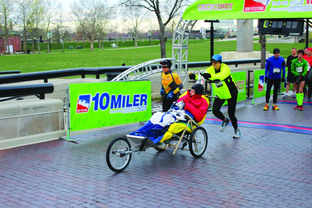 Shoulder patient pushes his brother in Indy Mini-Marathon